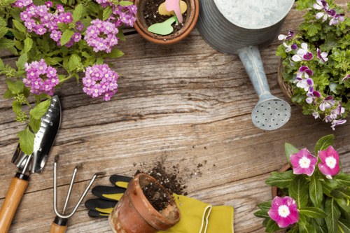 Front view of a Kilburn garden with tools and plants, representing Gardener Kilburn services